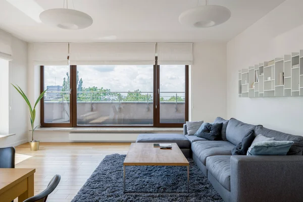 Simple living room with big window doors to spacious terrace