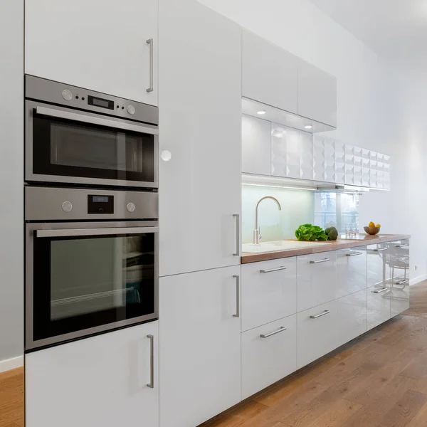 Small Kitchen White Cupboards Drawers Wooden Floor Silver Oven Microwave — Stock Photo, Image