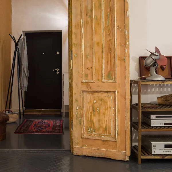 Amazing old wooden doors open to simple doorway in stylish tenement apartment