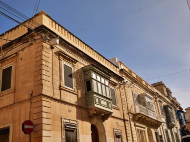Malta 'nın Rabat kentindeki tarihi kireçtaşı binasında Gallarija olarak bilinen geleneksel renkli Malta ahşap balkonları. Otantik Akdeniz mimarisi.