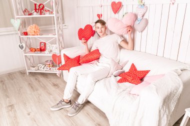 kanepede oturan beyaz giymiş yakışıklı adam