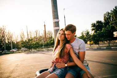 gün batımında sokakta oturan sevgi dolu çift