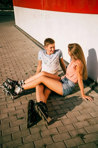 Couple sitting on the curb on a street