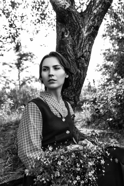 Outdoor Portret van een mooie brunette vrouw in blauwe jurk in het veld. Zwart-wit foto — Stockfoto