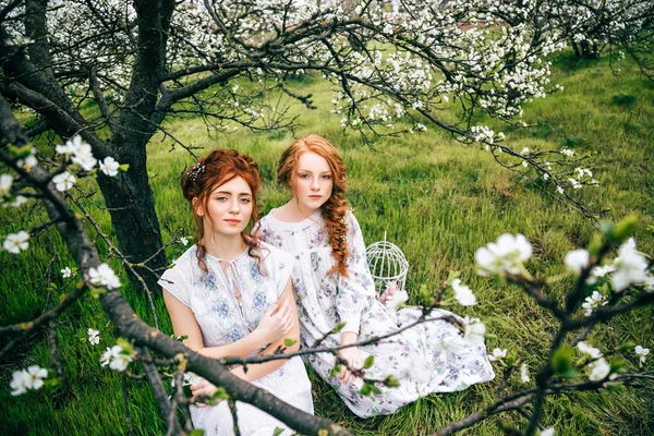 Portret van twee prachtige roodharige meisjes in de lentetuin — Stockfoto