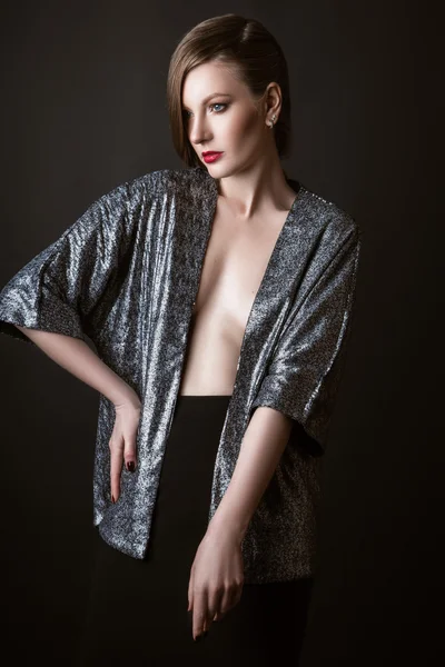 Fashion girl posing in the silver jacket. Studio photo. Black background — Stock Photo, Image
