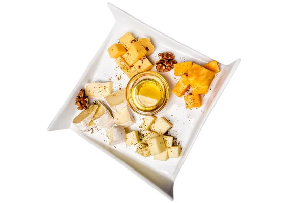 Cheese plate Assortment of various types of cheese and honey on white plate — Stock Photo, Image