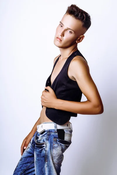 Attractive trendy young man with unbuttoned vest, standing on white background — Stock Photo, Image