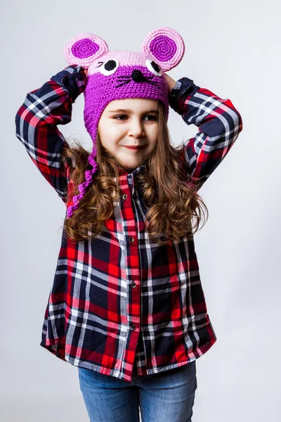 A little girl is in the cap of mouse. Studio photo — Stok fotoğraf