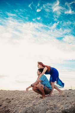  a young couple enjoys a mid summer late afternoon, on a wet san