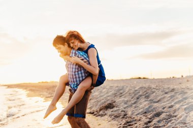  a young couple enjoys a mid summer late afternoon, on a wet san
