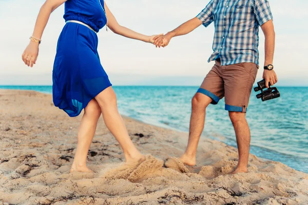 A young couple enjoys a mid summer late afternoon, on a wet san — Stock Fotó