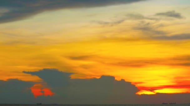 Embaçamento pôr-do-sol vermelho amarelo laranja nuvem no céu sobre o mar com barco de acabamento e navio de carga lapso de tempo — Vídeo de Stock