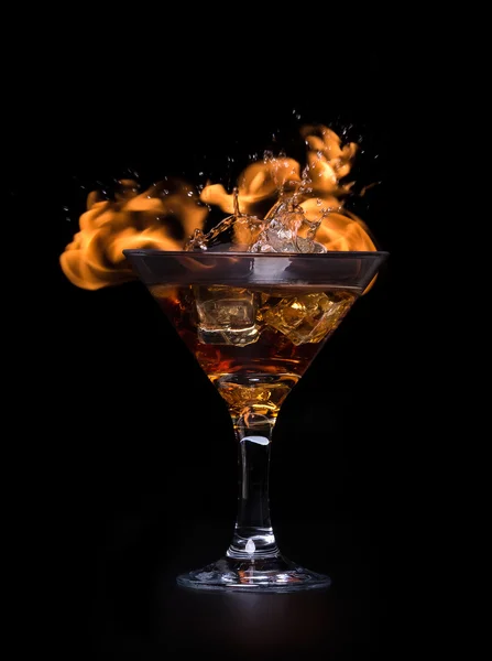 The concept of hot drink with ice cubes in a glass. On a black background. — Stock Photo, Image