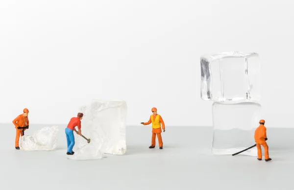 Miniature toy workers crash the ice for cold drinks. — Stock Photo, Image