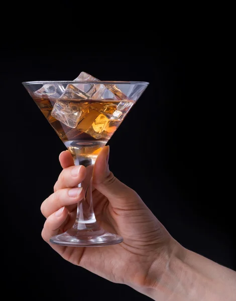 Hand holding glass of brandy isolated on black background — Stock Photo, Image