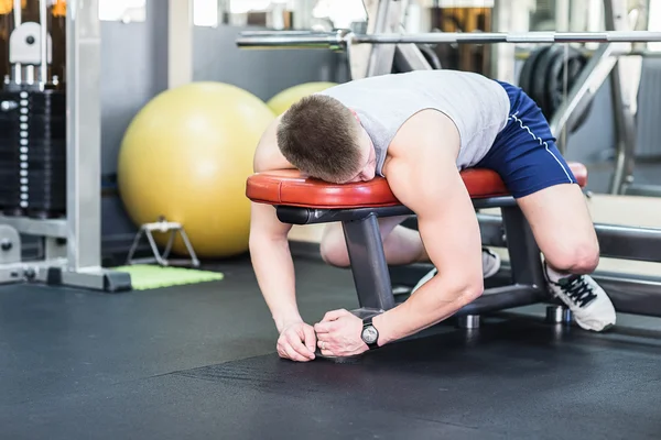 Tired and desperate men at the gym