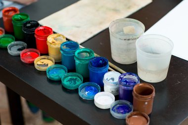 Boyalar ve fırçalar masaya vardır