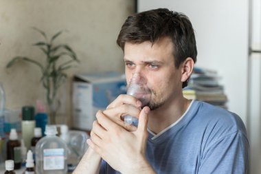 Man Inhaling Through Inhaler Mask clipart