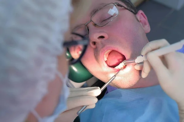 Dentista examinando las encías del paciente con sonda utilizando el método de diagnóstico por computadora. — Foto de Stock