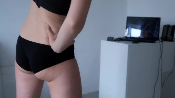 Woman with cellulite body is training on online workout looking at laptop. — Stock Video