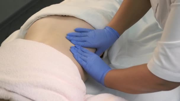 Doctor is massaging body of woman after injection of ozone gas in abdomen. — Stock Video