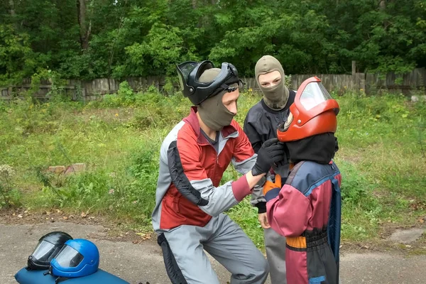 Instructor is wearing helmet on boy head preparing him to fly in air tube. — Stock Photo, Image