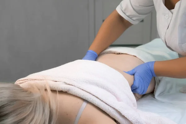 O médico está massageando o corpo da mulher após a injeção de gás ozônio no abdômen. — Fotografia de Stock