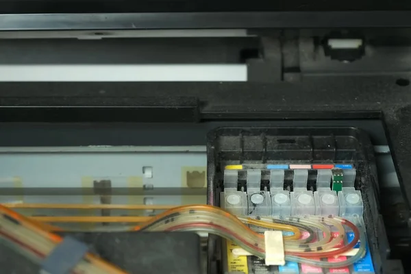 Continuous ink supply system is working in printer moving inside, closeup view.