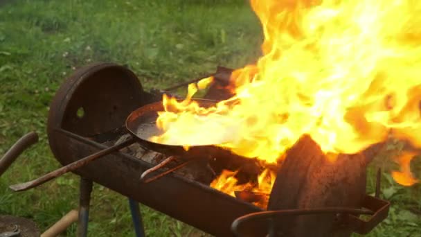 Mand stegning en skiver courgette på stegepande med olie og dens brændende i berømmelse. – Stock-video