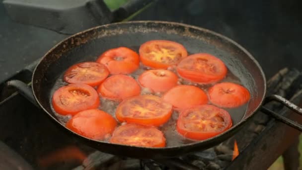 Fatias de tomates está fritando na frigideira com óleo na grelha, vista superior. — Vídeo de Stock