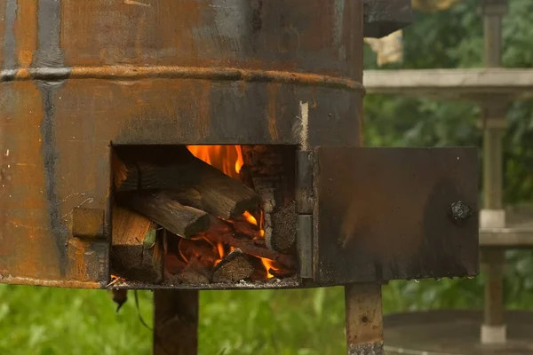 Firewood is burning in metal wood-burning stove for cooking on nature. — Stock Photo, Image