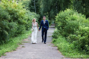 mutlu gelin ve damat yaz ormanda yürüyüş.