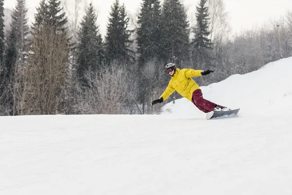 Snowboarder slides from the mountain — Stock Photo, Image