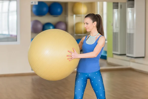 Young fitness woman doing slopes with fitball — Stockfoto