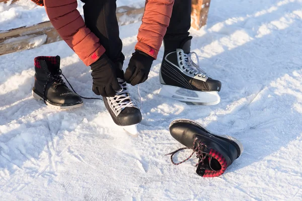 man wears a winter skates at the rink