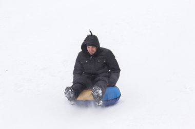 young man with roller coaster rides in the winter