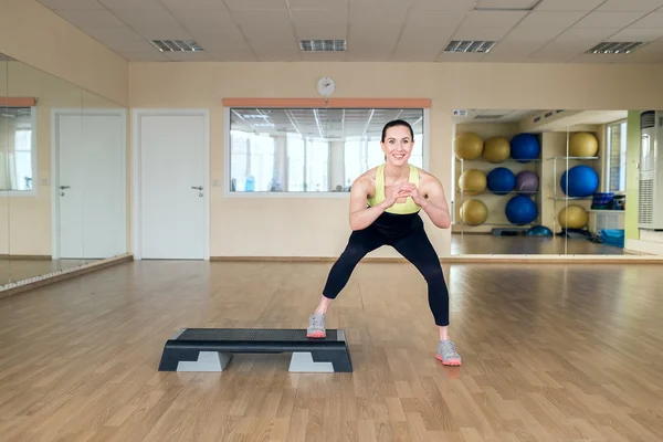 Mooie jonge vrouw doen fitness in de sportschool — Stockfoto