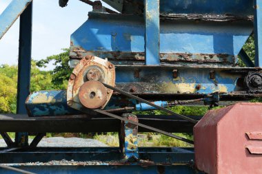 Endüstriyel tasarımın özünü bu detaylı makine sahnesiyle yakalayın. Yaşlanmış dokular ve çarpıcı mavi renkler büyüleyici bir açık hava ortamında..