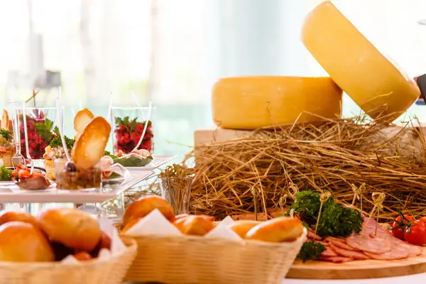 Pieces of cheese are on the table with different products. — Stock Photo, Image