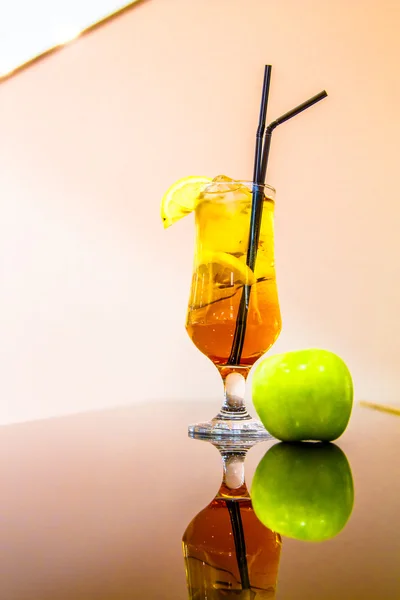 A glass of cocktail and Apple is on the black piano. — Stock Photo, Image