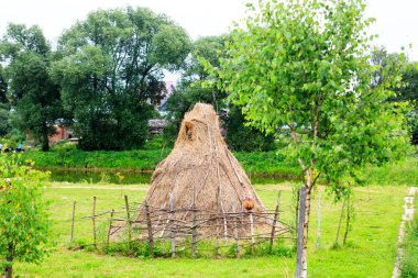 Samanlık, çit ve yaz yeşil zemin üzerine sepeti.