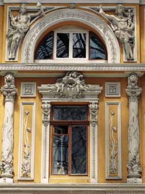 Süslü tarihi Avrupa şehir binasında güneşli heykel balkonu