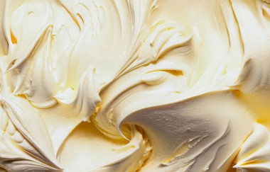 Düz kıvrımlı kremalı vanilyalı tereyağı kreması. Detaylı yakın plan doku arka planında.