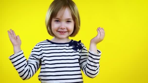 Little Girl Covers Her Face Her Hands Isolated Yellow Background — Stock Video