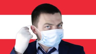 Avusturya bayrağının arka planında tıbbi koruyucu maskeli bir adam var. Coronavirus, COVID-19, SARS, nCov-19. Sağlık, güvenlik, kriz, karantina, durgunluk ve finans kavramı.