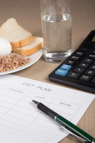 Diet plan with buckwheat,bread,eggs,water and calculator — Stock Photo, Image