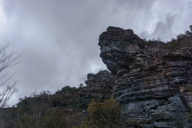 Rock formation at the impressive Vikos gorge in the Zagoria region at Pindus Mountains on a dark winter day with atmospheric mood, Epirus, Greece