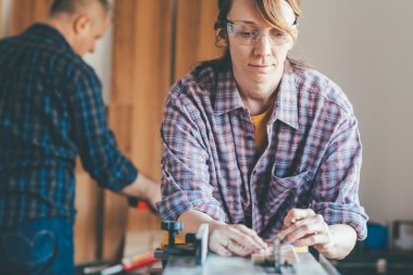 woman working at carpenter shop with teacher clipart