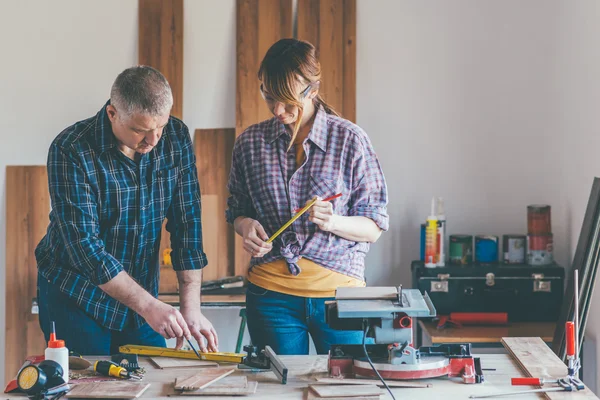 Woman working at carpenter shop with teacher — Stock Photo, Image